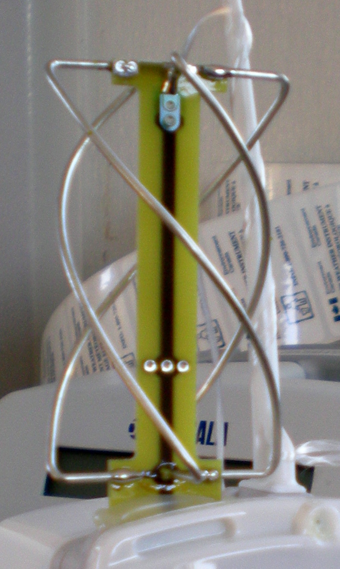 Figure 5 — A 137 MHz quadrifilar helix (QFH) antenna — four helical conductors self-phased for the wide, nearly-hemispherical RHCP pattern that makes the QFH the no-tracking workhorse for polar weather-satell…