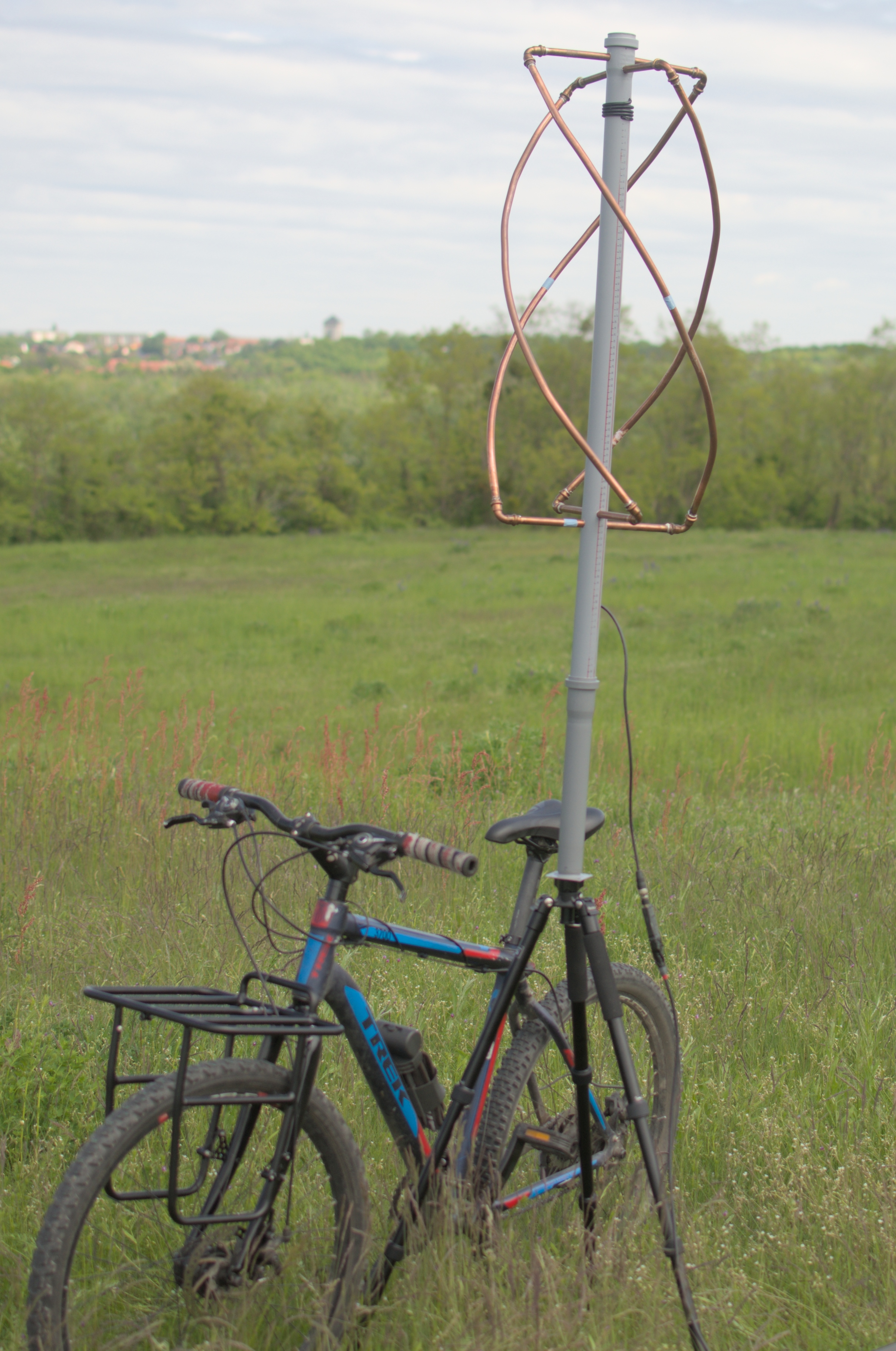 Figure 3 — A 137 MHz quadrifilar helix built from copper tube on a fibreglass mast — two bifilar loops with a half-turn twist, self-phased by the difference in their sizes, with the downlead inside the mast. …