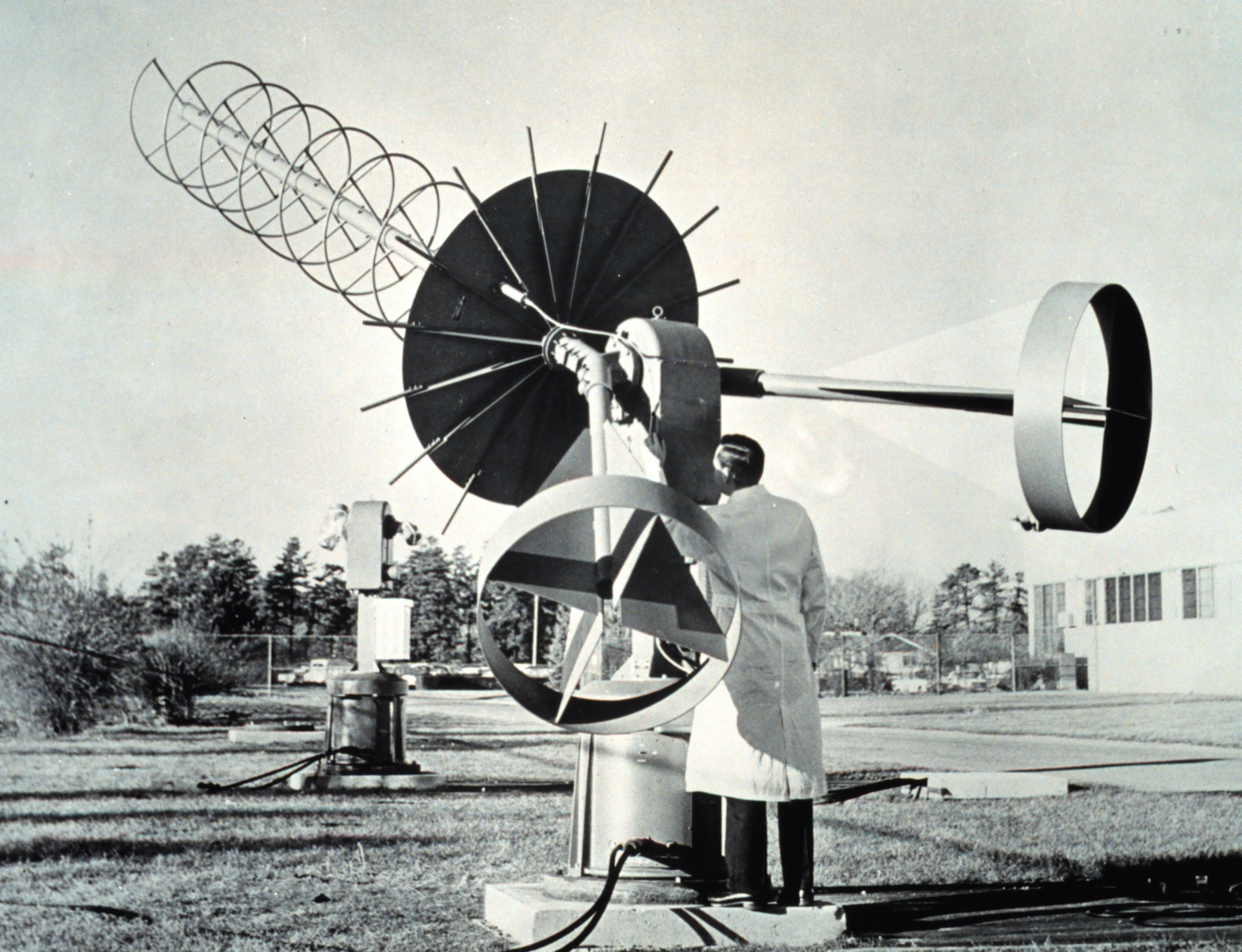 Figure 7 — A 1960s NOAA ground station: an axial-mode helix of about six turns over a solid circular ground plane, on a manually-tracked az/el pedestal, built to receive the Automatic Picture Transmission dow…