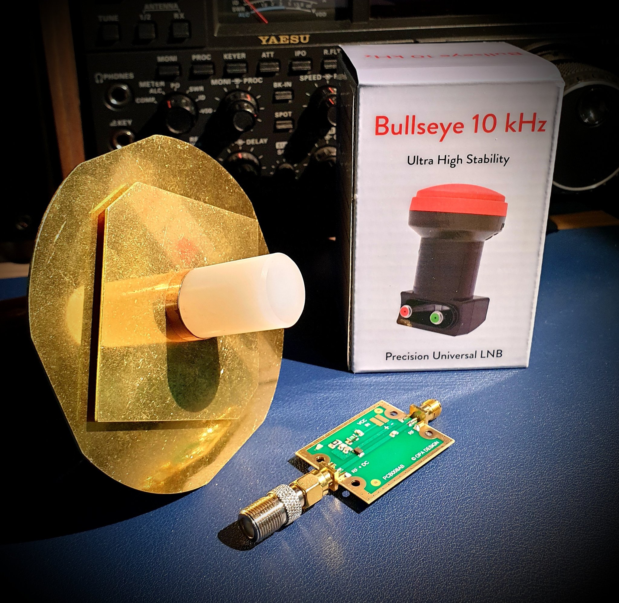 Figure 10 — An offset Ku-band dish with a PLL LNB at the feed arm — the QO-100 receive chain, aimed once at the 26°E geostationary slot and bolted down (no tracking, since the bird is motionless in the sky). S…